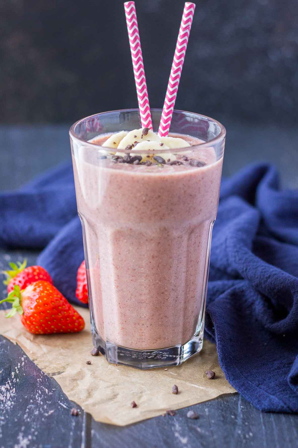 Strawberry Banana Smoothie served in a glass toped with banana slices and chocolate