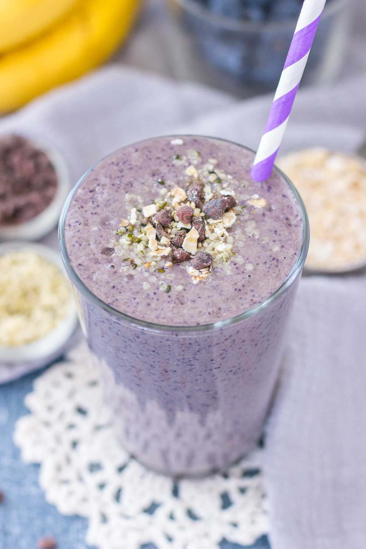 Healthy Blueberry Banana Smoothie with fresh fruits and oats served in a glass with a straw