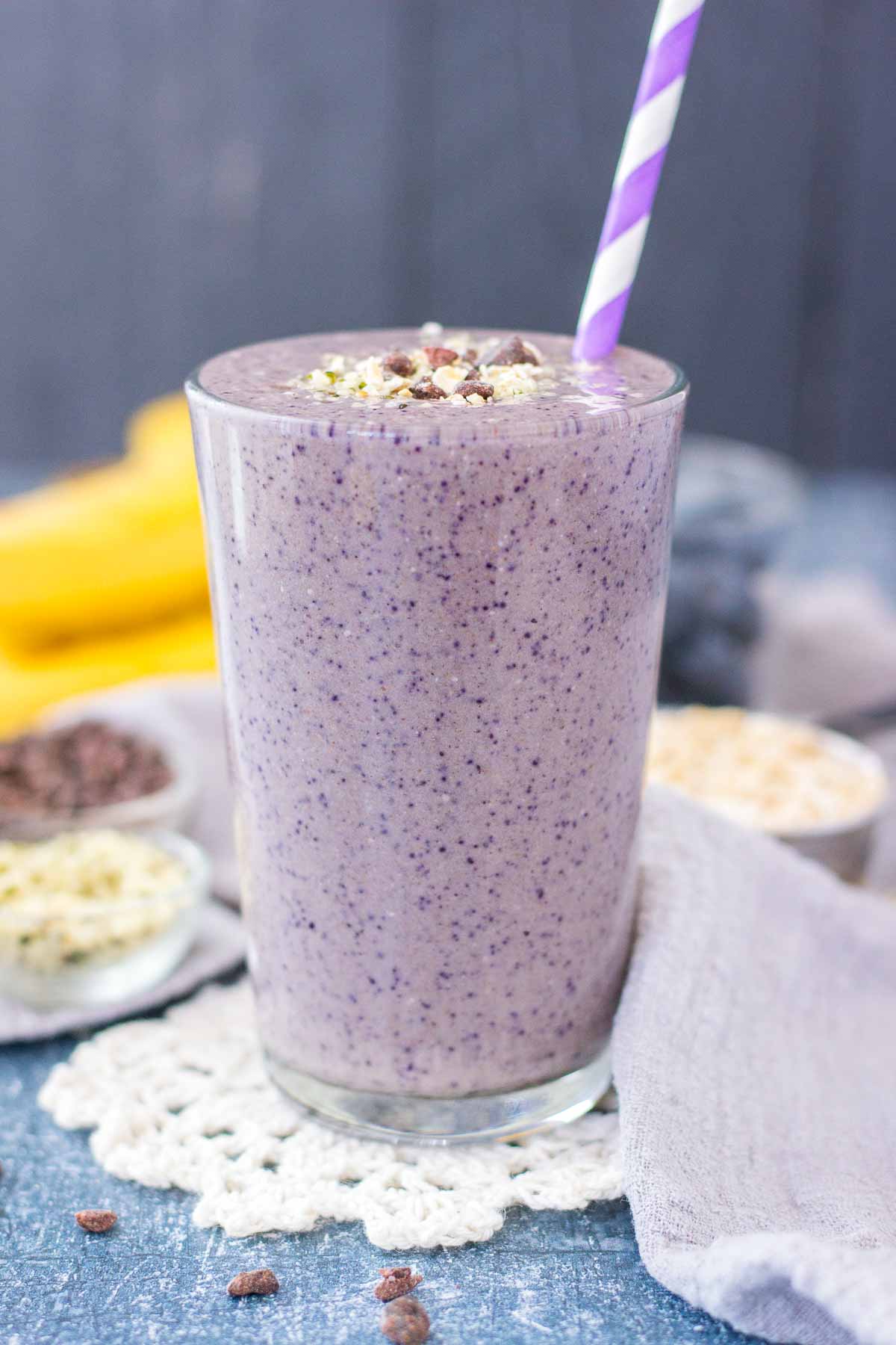 Healthy Blueberry Banana Smoothie with fresh fruits and oats served in a glass with a straw