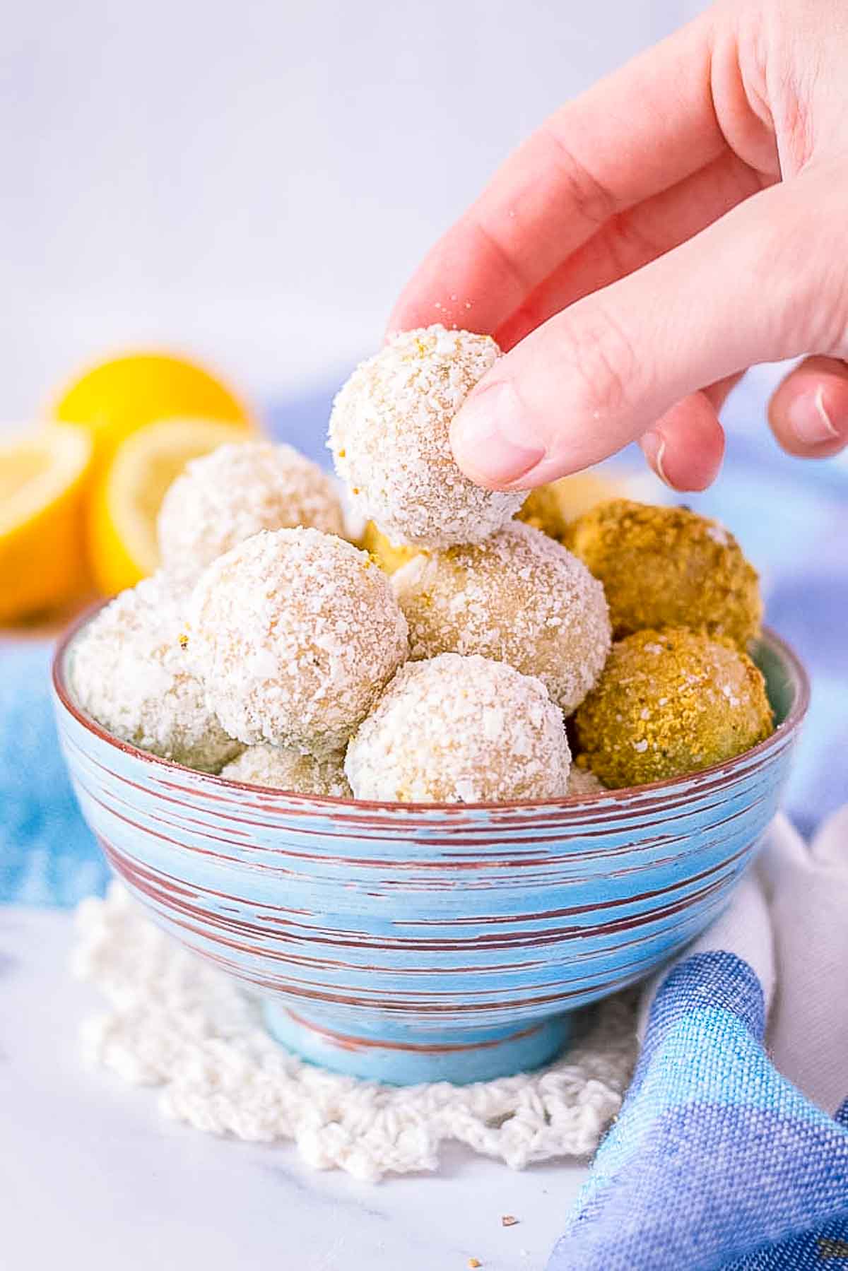 Hand picking Lemon Coconut Energy Balls