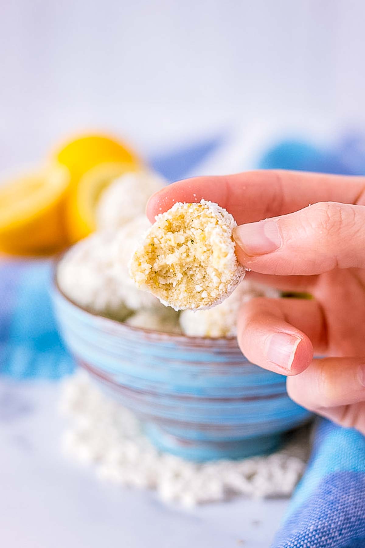 Hand holding Lemon Coconut Energy Balls