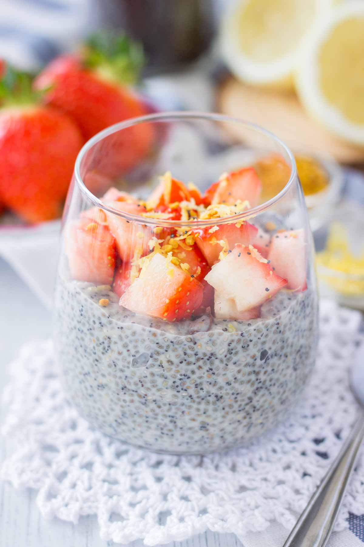 Lemon Poppy Seed Chia Pudding served in a glass topped with fresh strawberries