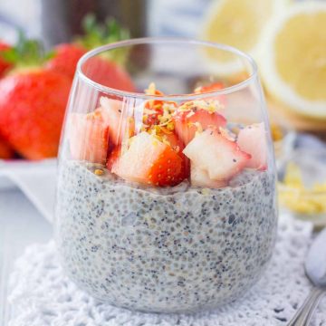 Lemon Poppy Seed Chia Pudding served in a glass topped with fresh strawberries