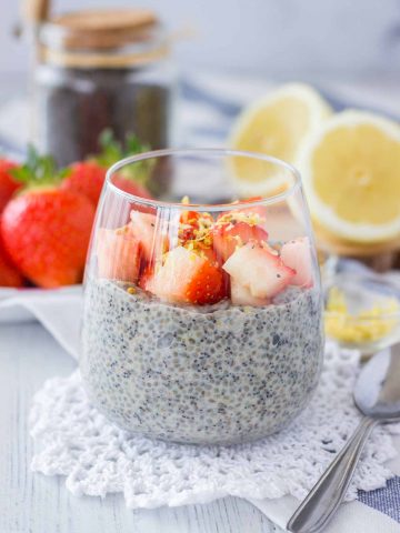Lemon Poppy Seed Chia Pudding served in a glass topped with fresh strawberries