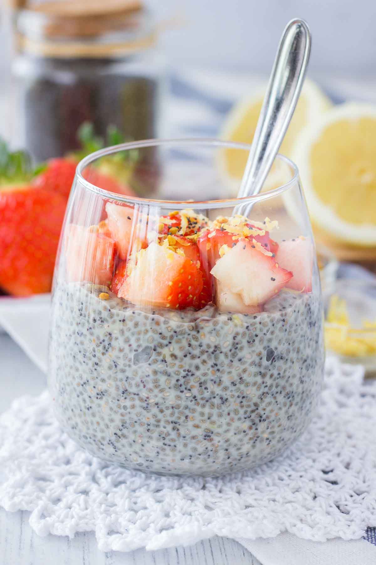 Lemon Poppy Seed Chia Pudding served in a glass topped with fresh strawberries