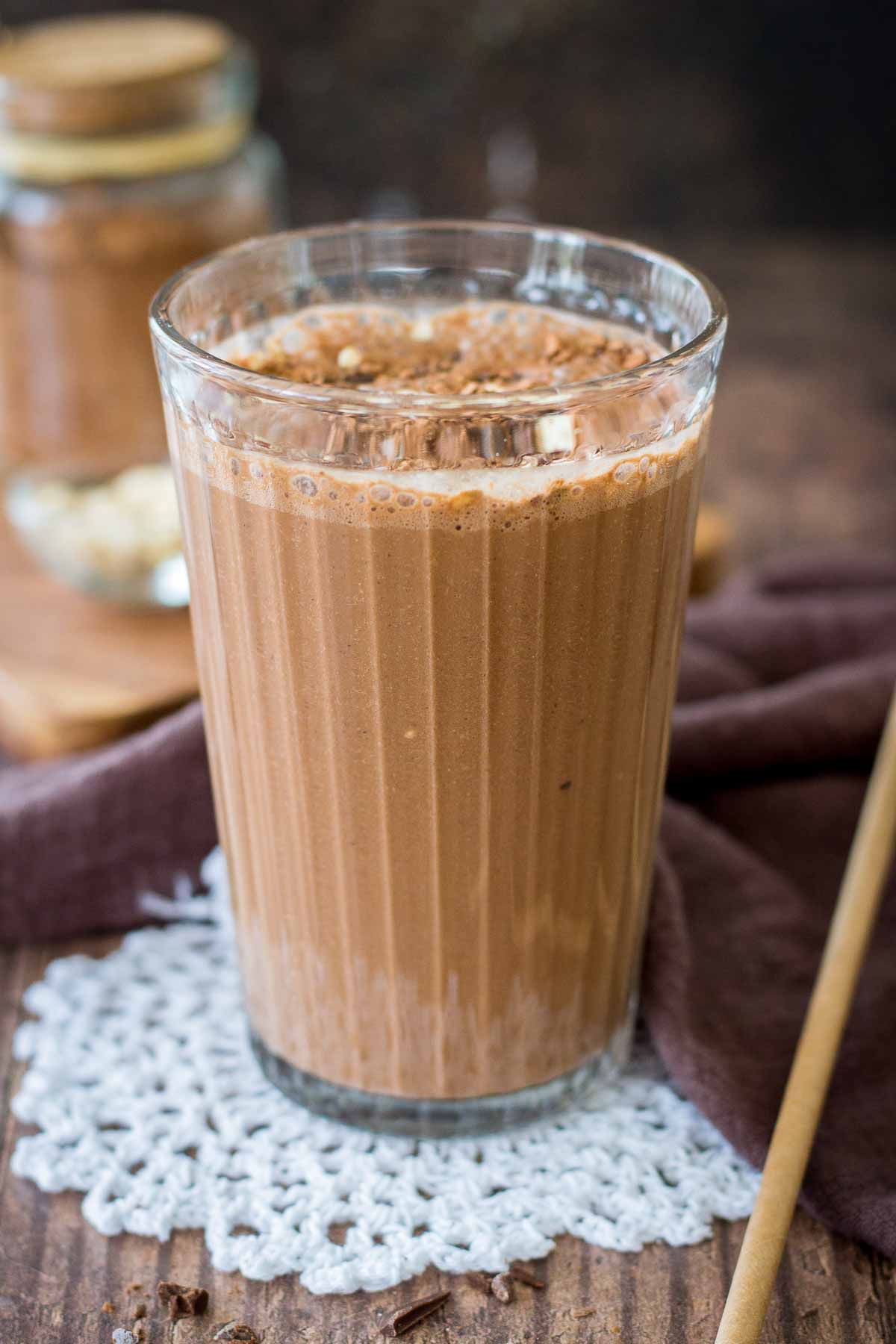 Coffee Smoothie served in a smoothie glass topped with cacao, oats and chocolate