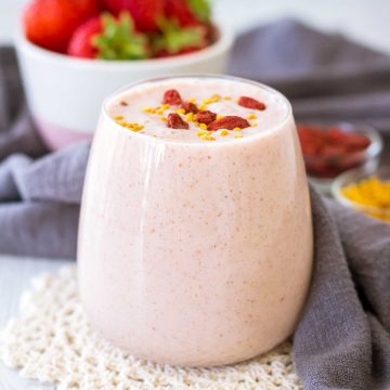 Strawberry Peanut Butter Smoothie served in a glass topped with goji berries