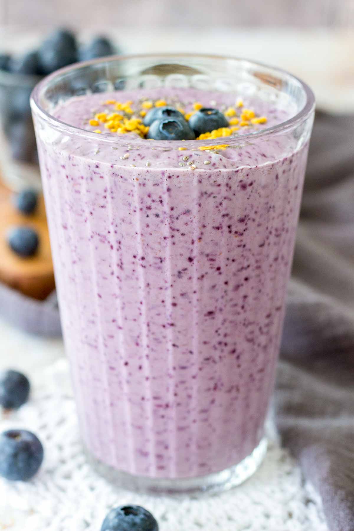 Blueberry Chia Smoothie served in a tall glass topped with fresh blueberries