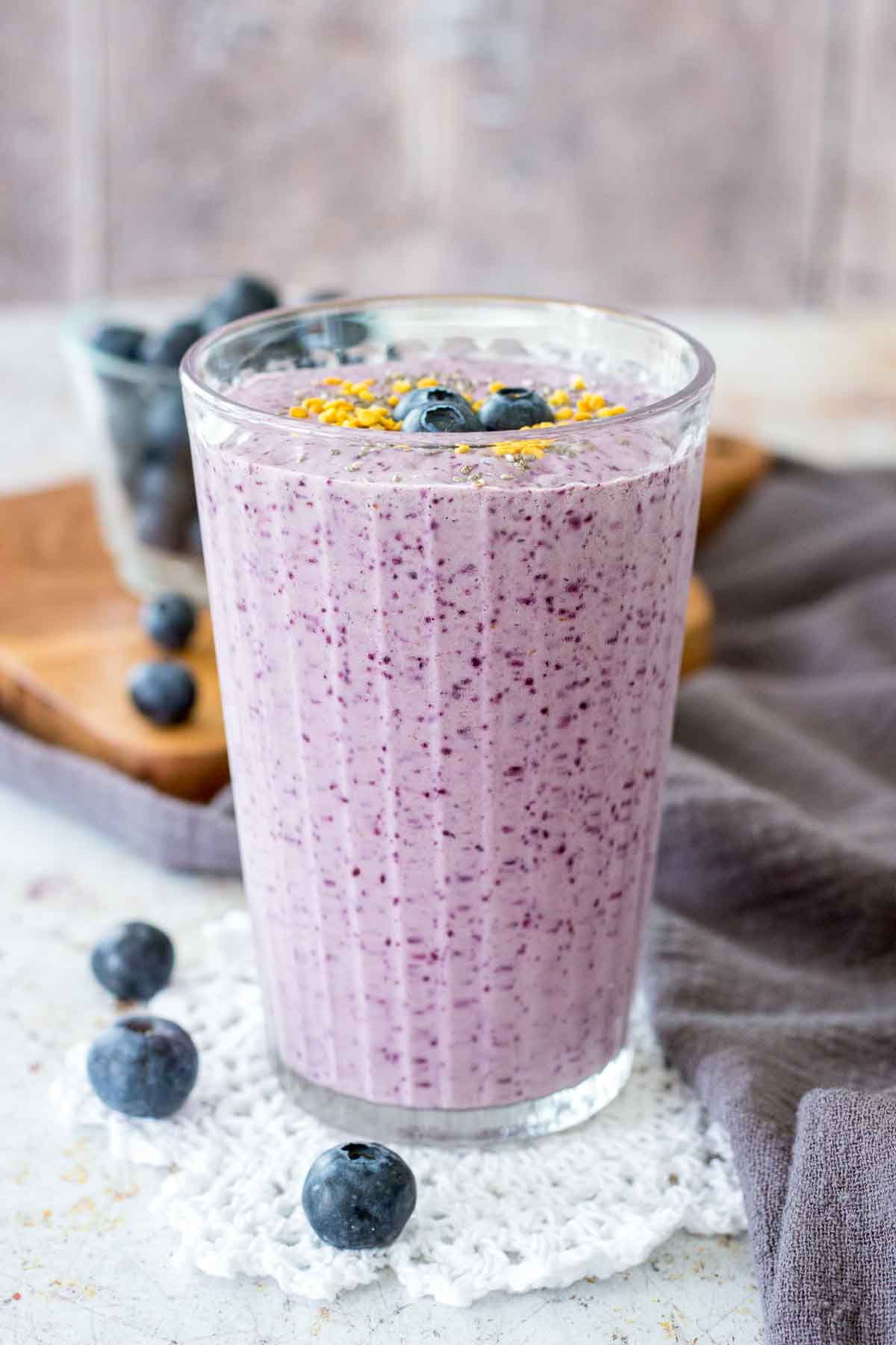 Blueberry Chia Smoothie served in a tall glass topped with fresh blueberries
