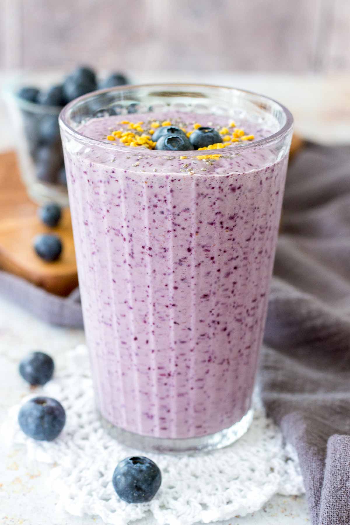 Blueberry Chia Smoothie served in a tall glass topped with fresh blueberries