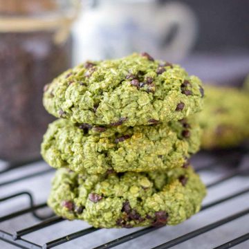Matcha Chocolate Chip Cookies stacked on a cooling rack