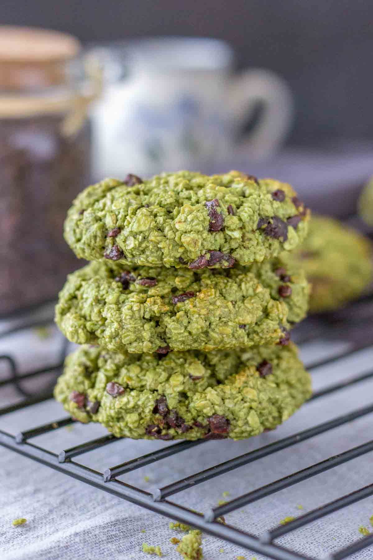 Matcha Chocolate Chip Cookies stacked on a cooling rack