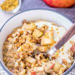 Apple Cinnamon Oatmeal served in a bowl topped with diced apples, walnuts and yogurt