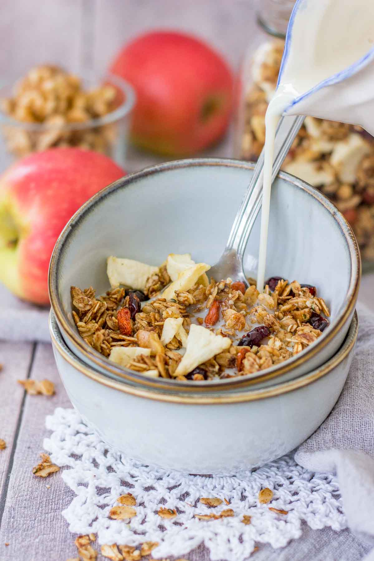 Apple Cinnamon Granola served in a bowl with a milk