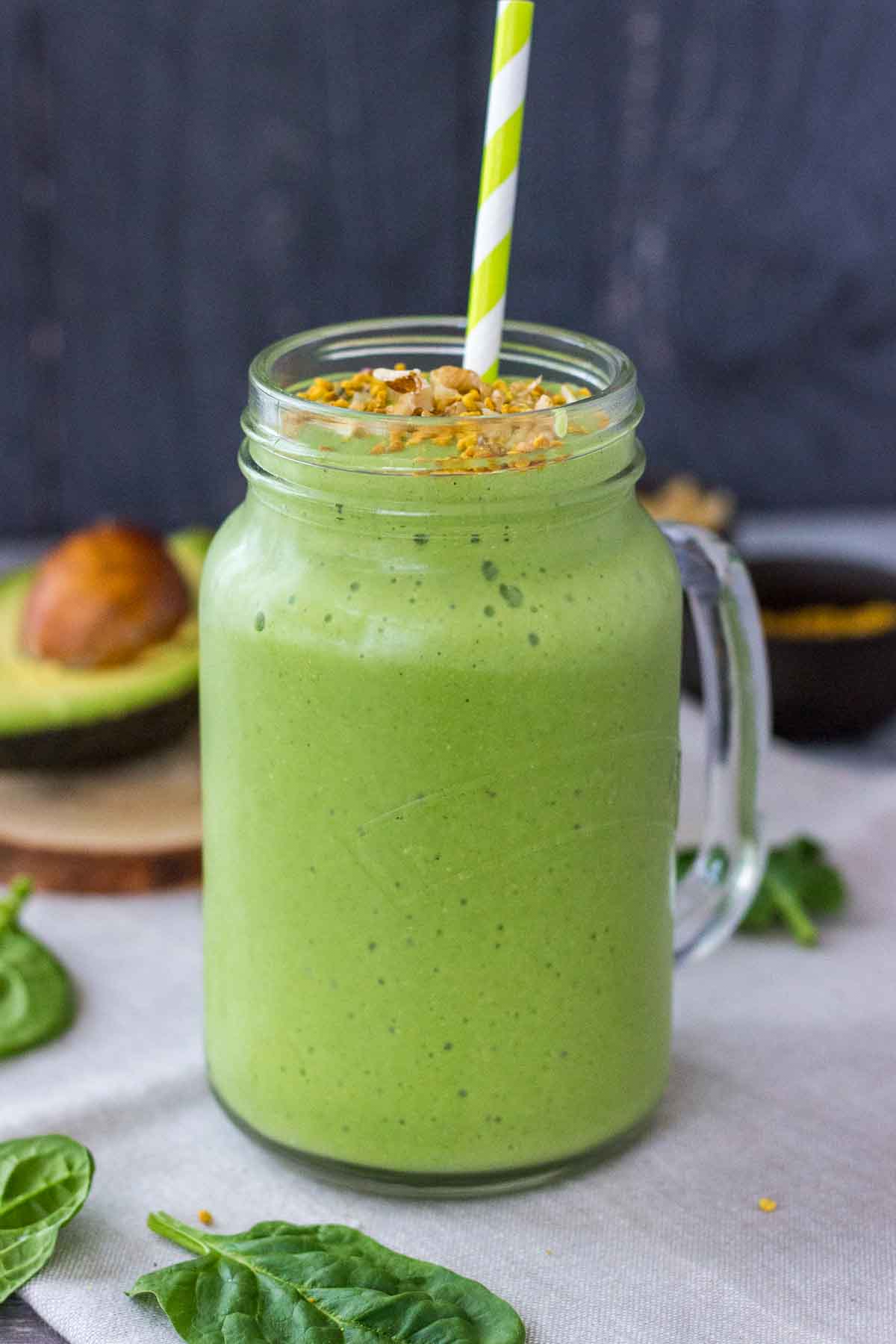 Avocado Smoothie in a glass with a straw