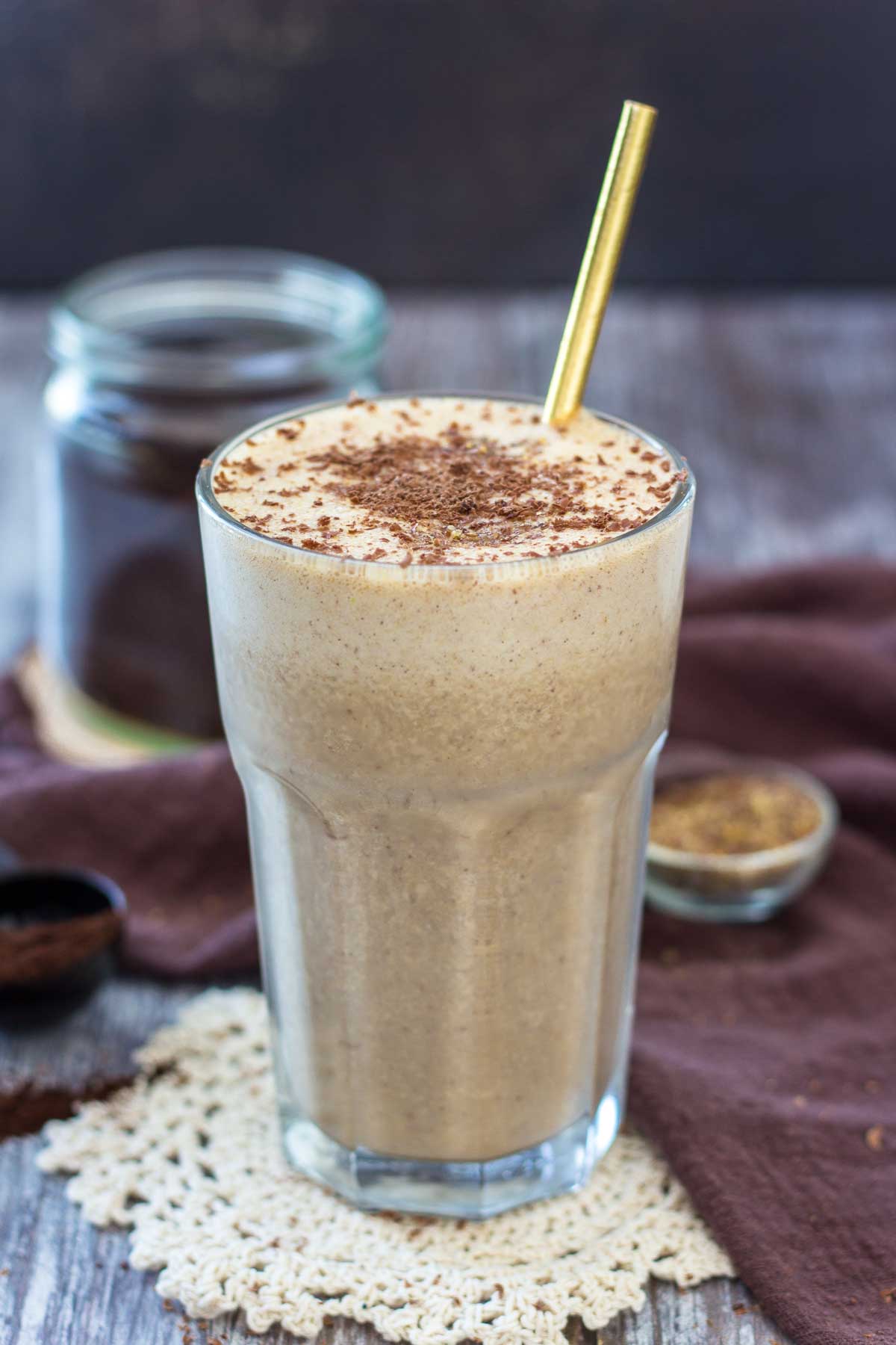 Coffee Protein Smoothie in a tall glass with a straw