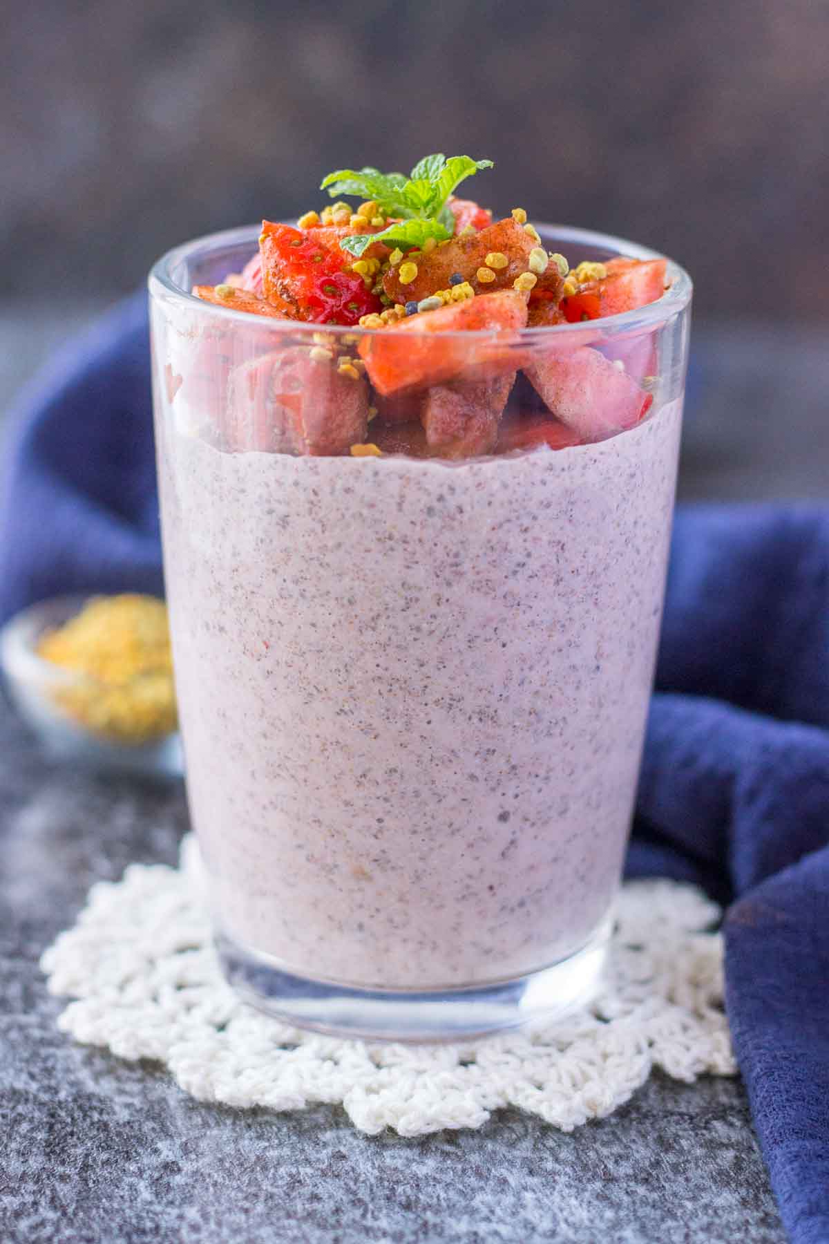 Strawberry Chia Pudding served in a glass jar topped with fresh strawberries