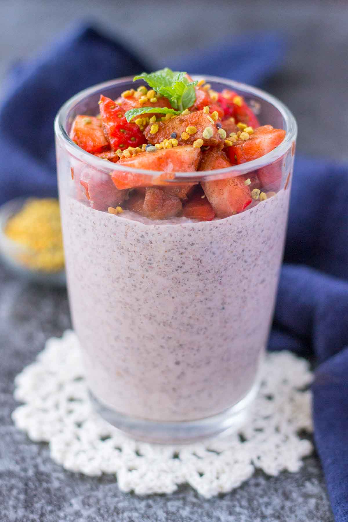 Strawberry Chia Pudding served in a glass jar topped with fresh strawberries