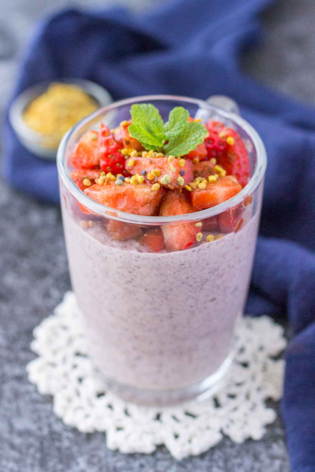 Strawberry Chia Pudding served in a glass jar topped with fresh strawberries