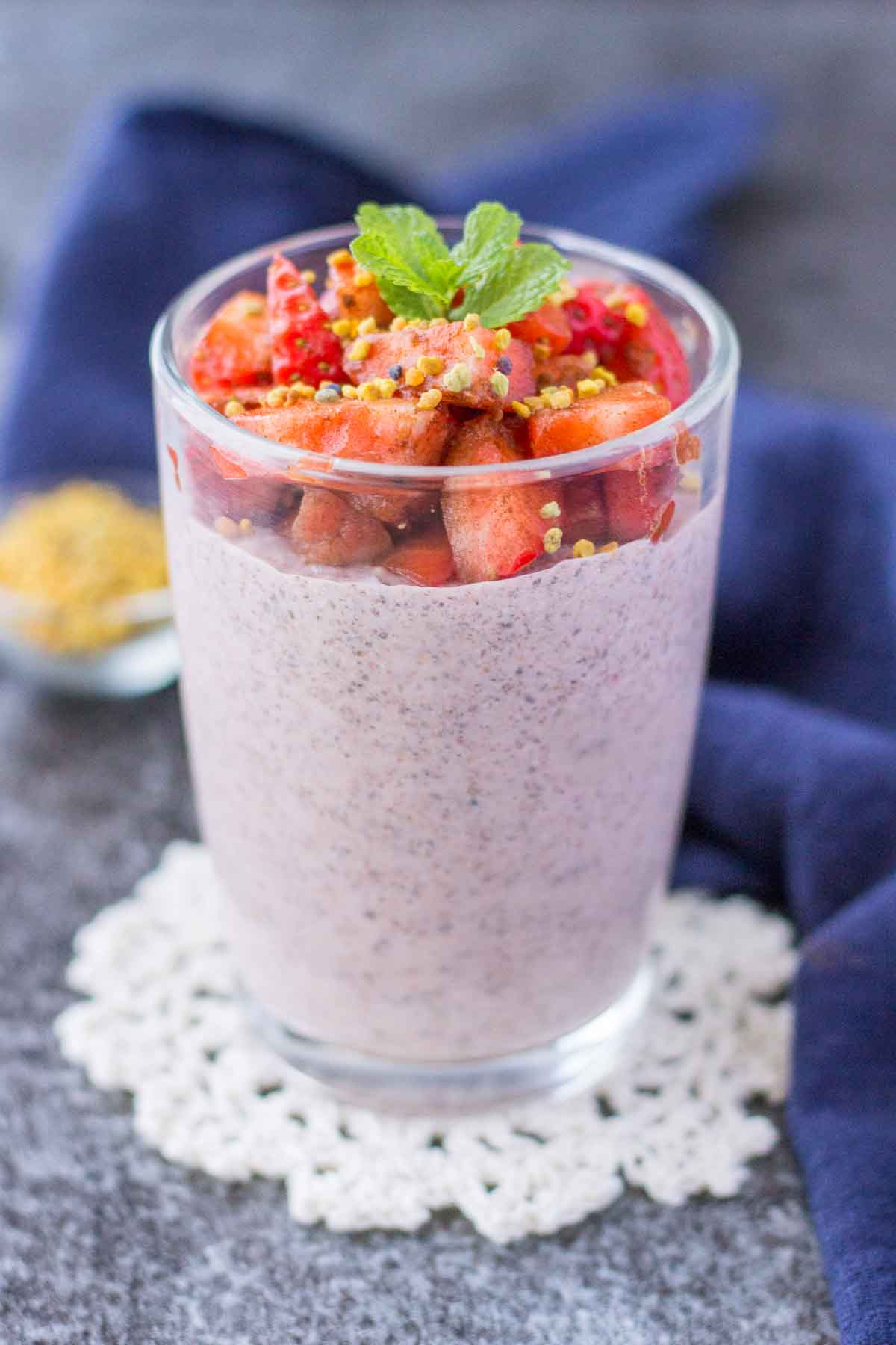 Strawberry Chia Pudding served in a glass jar topped with fresh strawberries