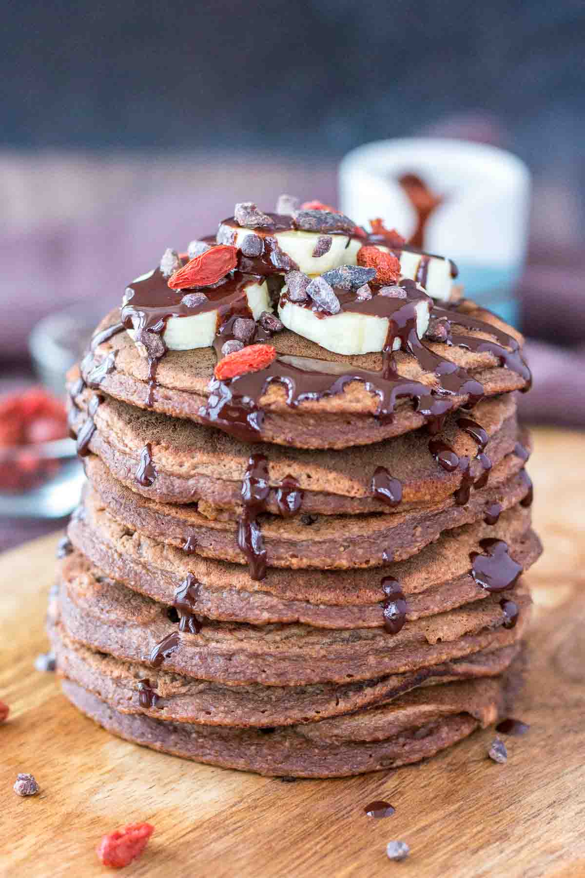 chocolate banana pancakes served on a wooden plate