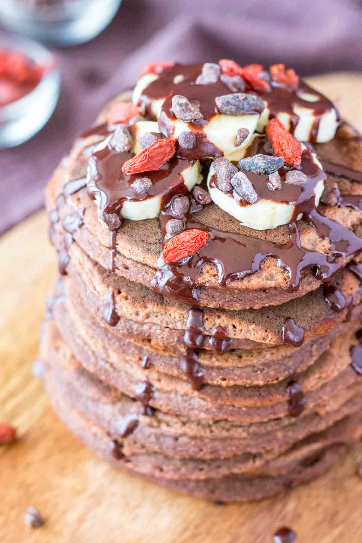 chocolate banana oatmeal pancakes on a wooden plate