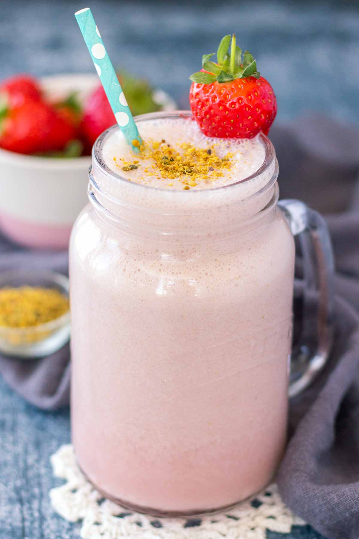 Homemade Strawberry Milk in a glass with a straw